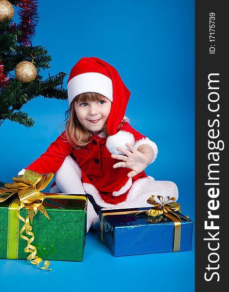 Girl In Santa Costume Playing With Gifts