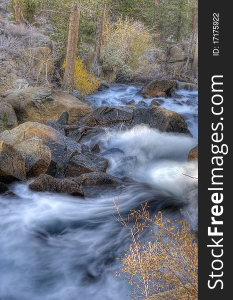 Artistic creamy river rapids with rocks. Artistic creamy river rapids with rocks