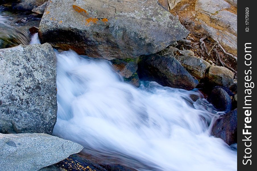 Artistic creamy river rapids with rocks. Artistic creamy river rapids with rocks