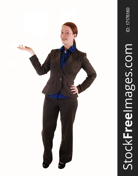 A business woman in a brown suit standing front the front in the studio, and showing something with her hand, for white background. A business woman in a brown suit standing front the front in the studio, and showing something with her hand, for white background.