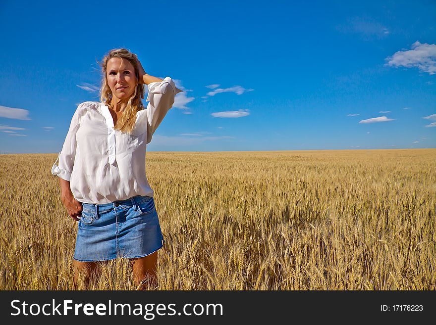 A woman Stands in a wheat field. A woman Stands in a wheat field