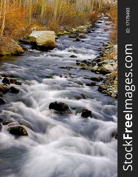 Artistic creamy river rapids with rocks. Artistic creamy river rapids with rocks