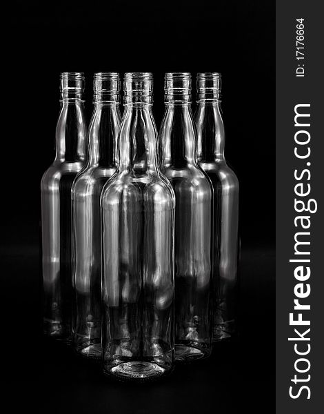 Empty bottles collection, colorless, isolated on black backgrounde