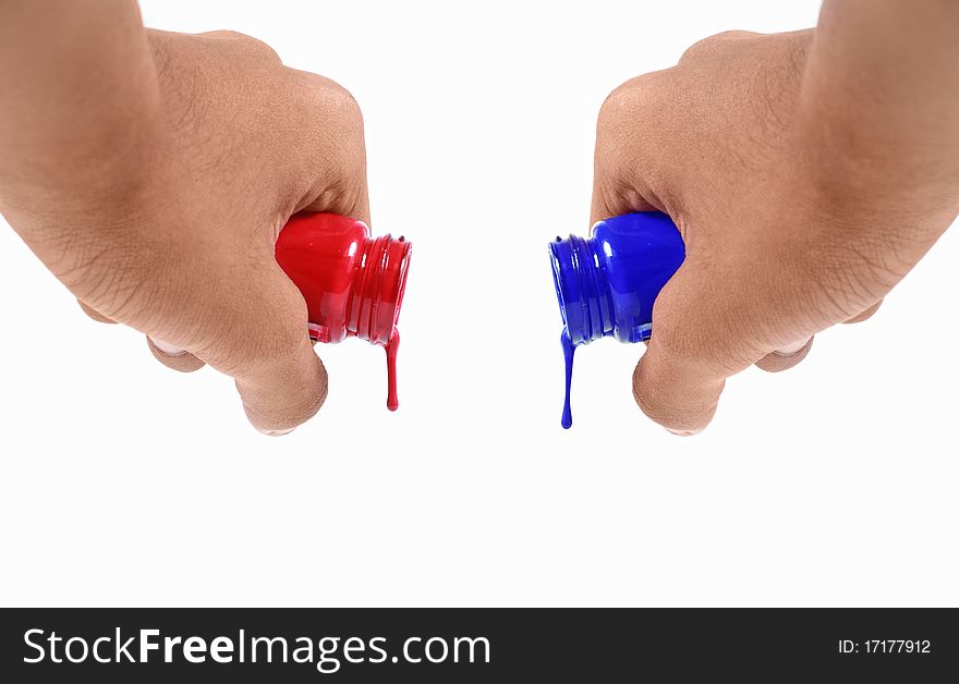 Both hands pouring blue and red water colors all at once. Both hands pouring blue and red water colors all at once