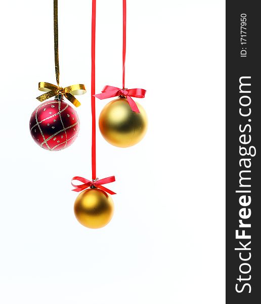 Christmas balls hanging with ribbons on white background