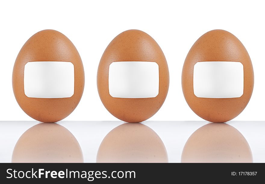 Three standing eggs labeled with blank paper. Three standing eggs labeled with blank paper
