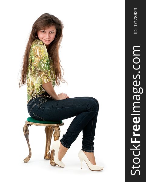 Portrait of a young woman sitting on a chair isolated on white background