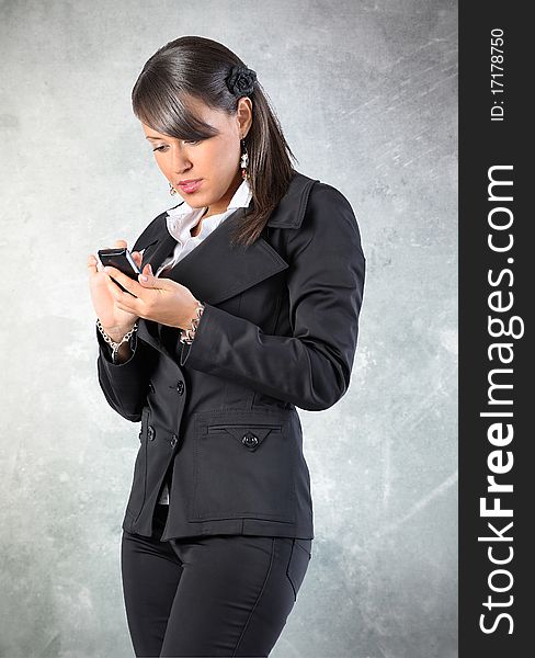 Woman is writing/readind a sms on a phone. Grounge background. Woman is writing/readind a sms on a phone. Grounge background