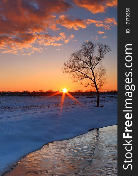 A colorful sunrise over the river winter morning. A colorful sunrise over the river winter morning