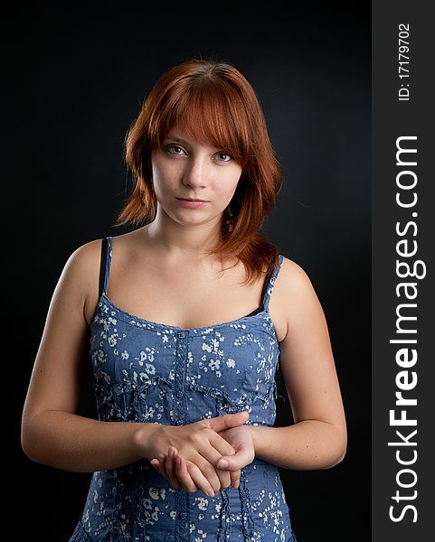 Portrait of girl with her red hair looking at the camera