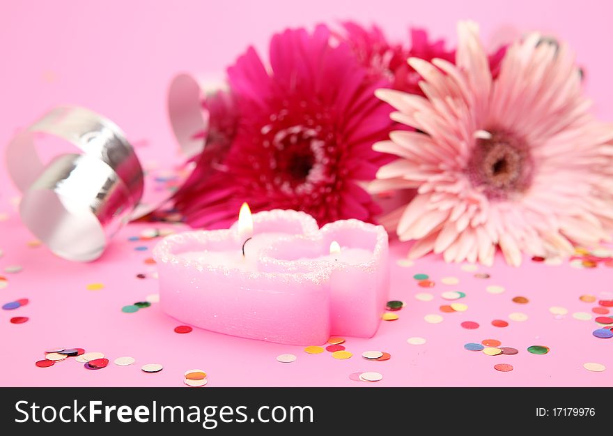 Pink flowers and burning candles. Pink flowers and burning candles
