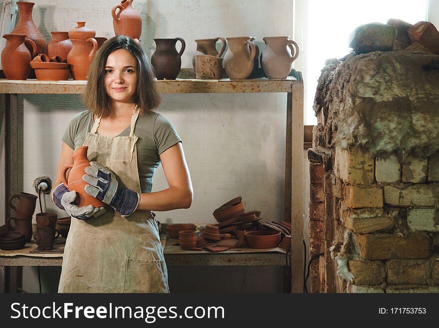 Girl in apron at authentic pottery workshop