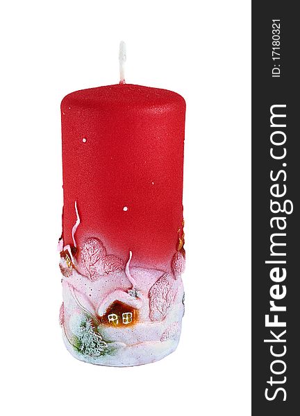 Decorative christmas candle of red color with the image of rural small houses. Closeup. Isolated on white. Decorative christmas candle of red color with the image of rural small houses. Closeup. Isolated on white.