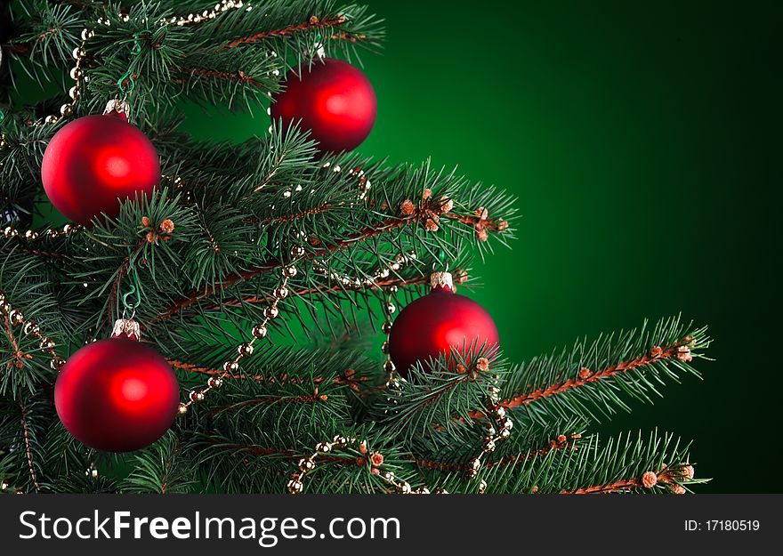 Red ornament on a christmas tree with copy space. Red ornament on a christmas tree with copy space.