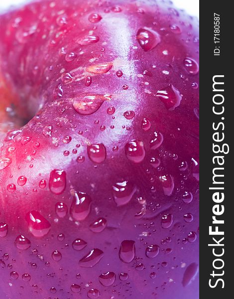 Close up of a red apple with water drops