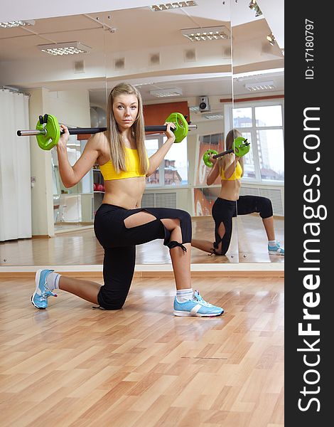 Beautiful girl with weight gym indoors