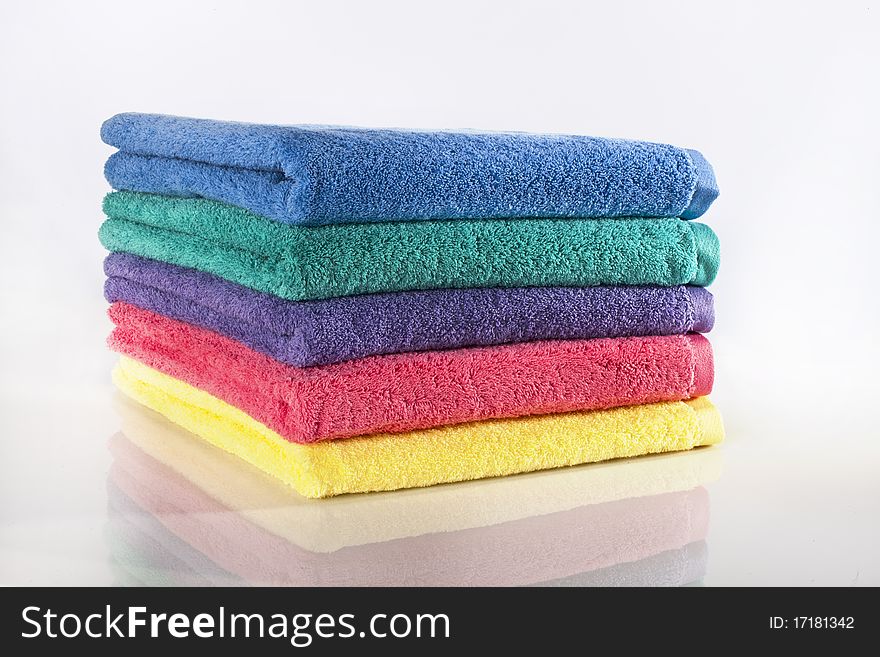 Bath towels against a white background in a studio environment. Bath towels against a white background in a studio environment