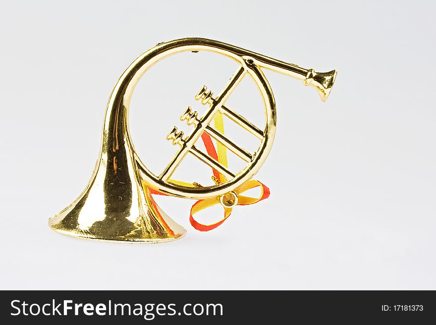 Christmas trumpet on red background