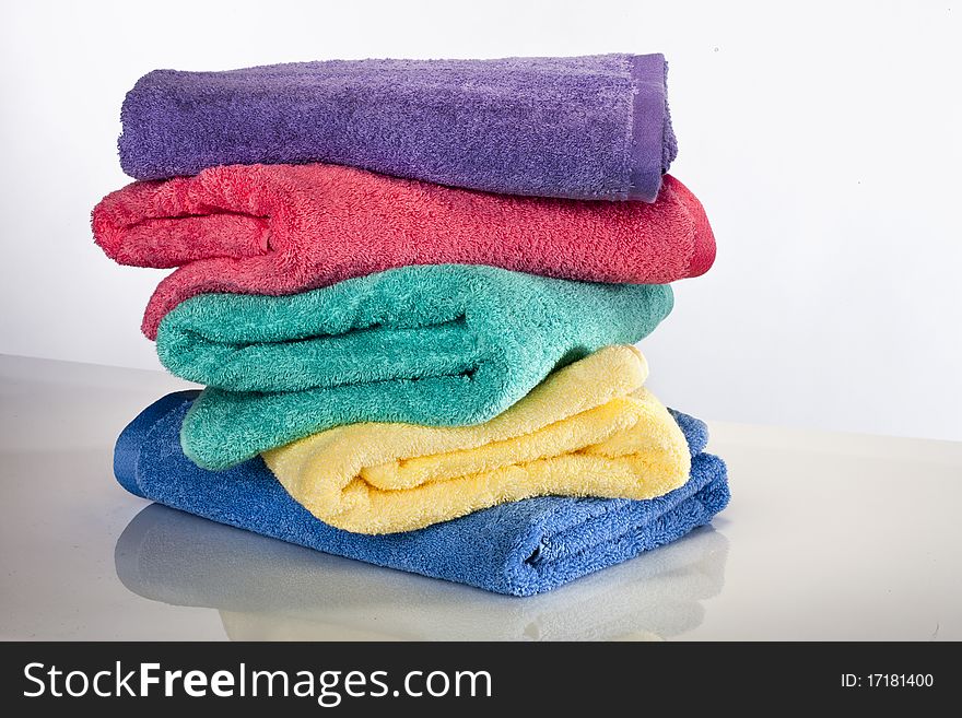 Bath towels against a white background in a studio environment. Bath towels against a white background in a studio environment