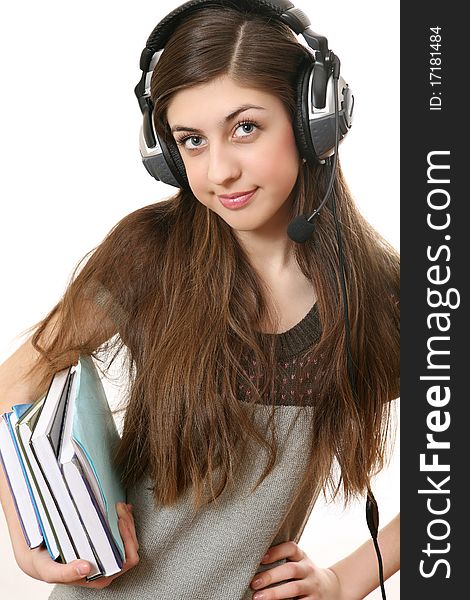 The girl in headphones with books