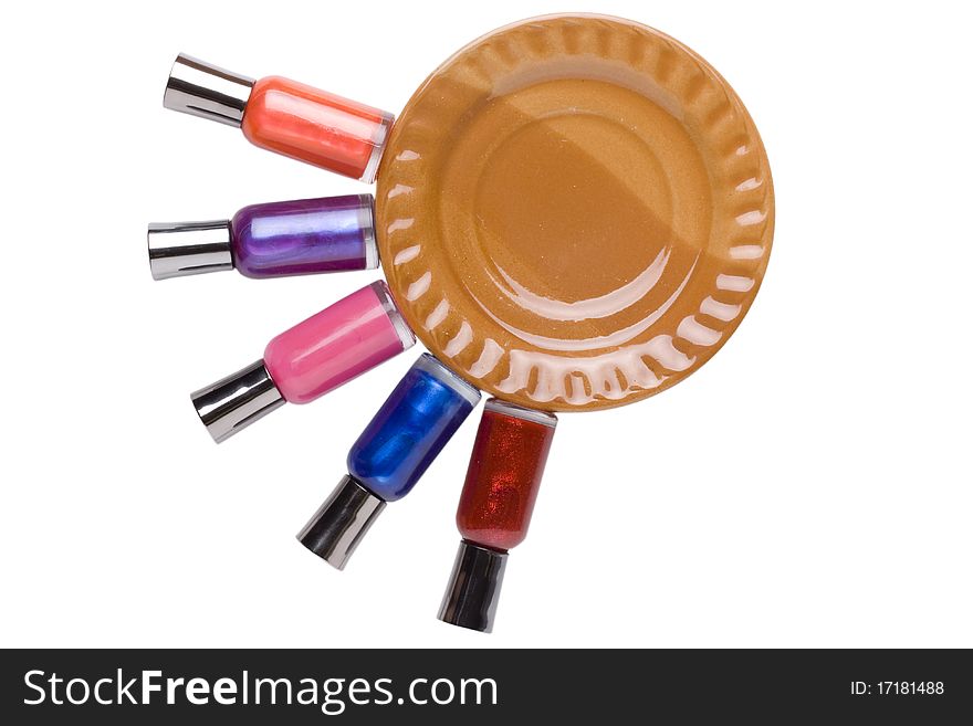 Nail polish bottles neatly placed around a brown plate.