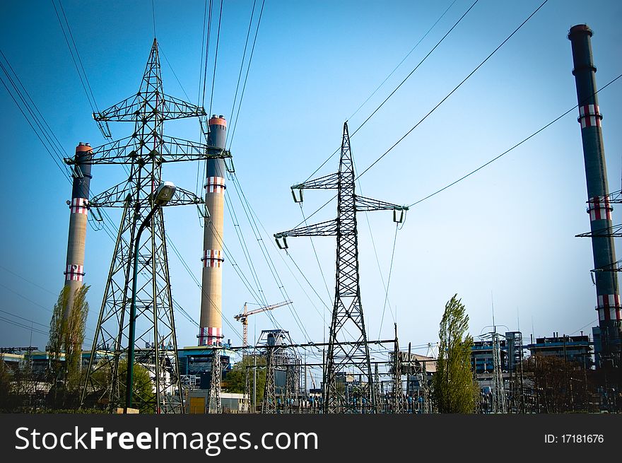 Posts against blue sky and factory. Posts against blue sky and factory