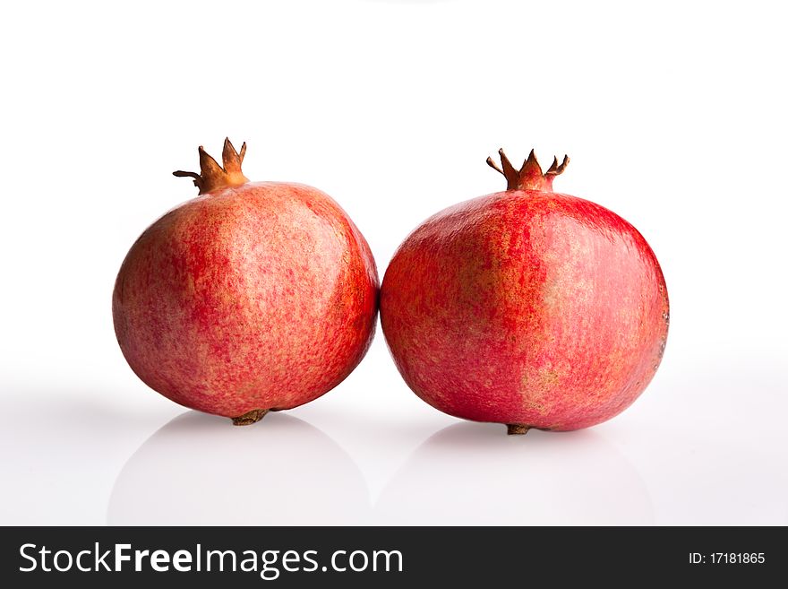 Two pomegranates on white background
