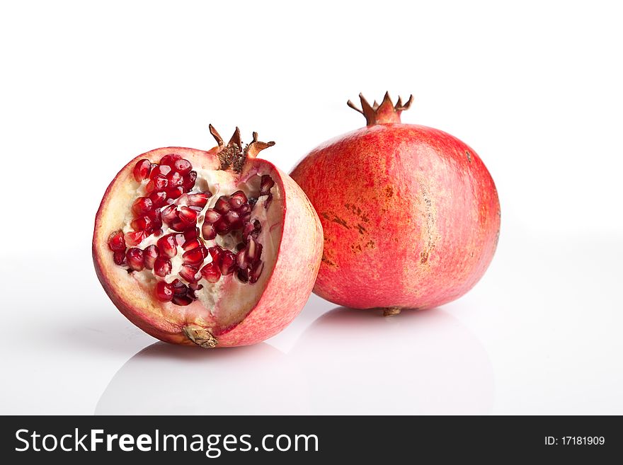 Juicy opened pomegranate on white background