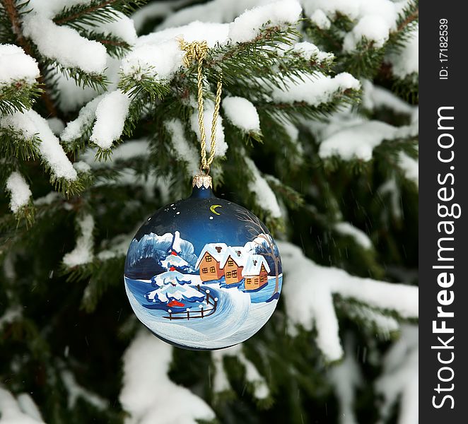 New Year's sphere on a snow-covered fur-tree