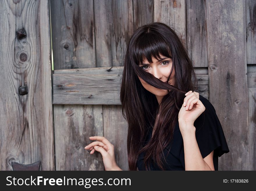 Young beautiful girl the brunette, holds hair