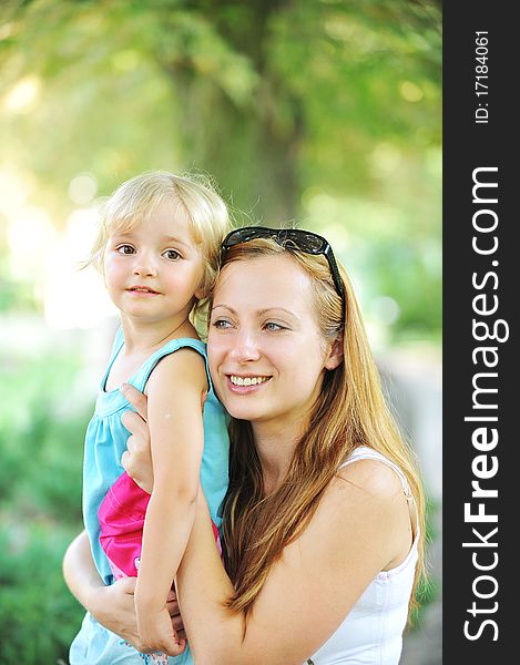 Mother and daughter in summer park