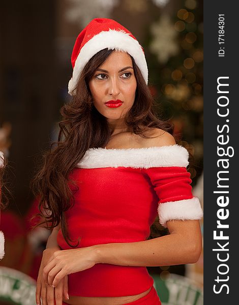 Beautiful young brunette woman with long hair dressed as Santa. Beautiful young brunette woman with long hair dressed as Santa