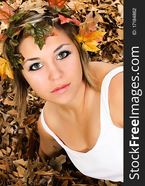 Beautiful young woman in fall colored leaves close up portrait. Beautiful young woman in fall colored leaves close up portrait.