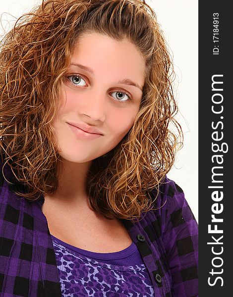 Beautiful 13 year old teen girl smiling over white background.