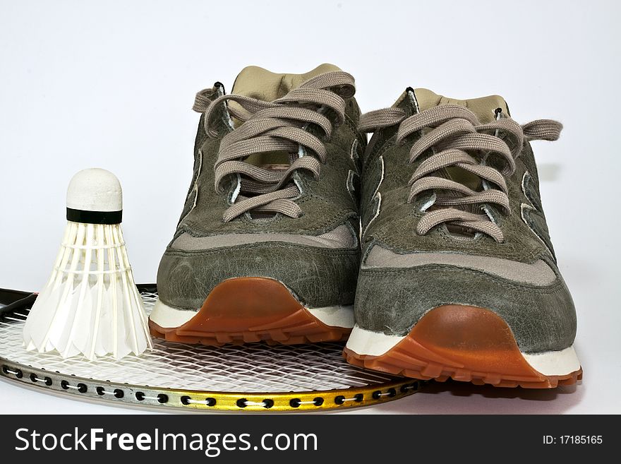 Shoes, badminton racket and shuttlecock on a white background. Shoes, badminton racket and shuttlecock on a white background