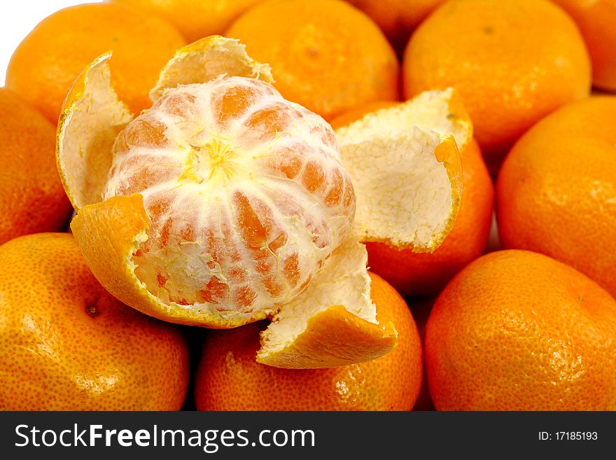 Fresh peeled tangerine on other tangerines
