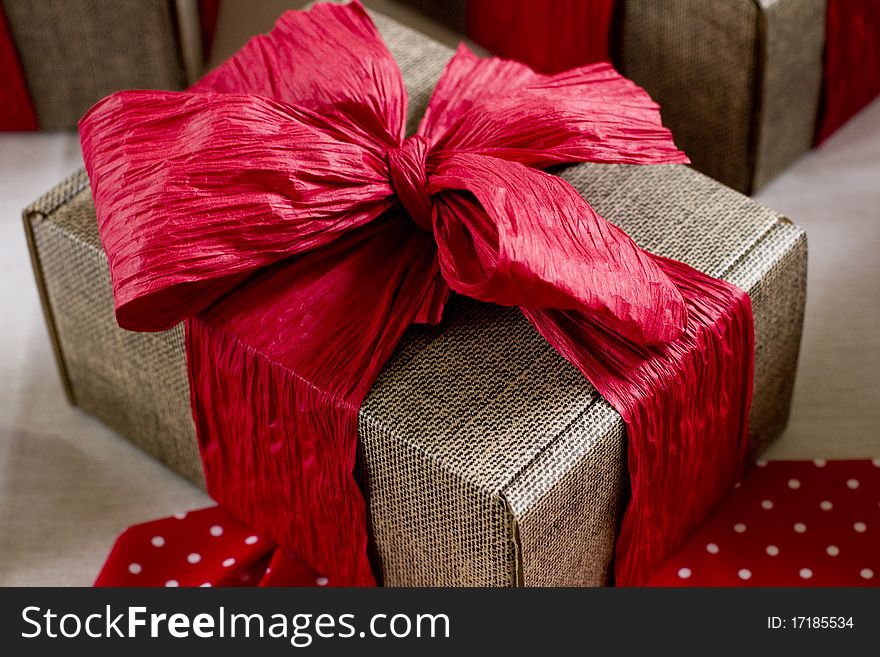 Hand made gift wrapped boxes with red crinkle paper bow tie. Hand made gift wrapped boxes with red crinkle paper bow tie