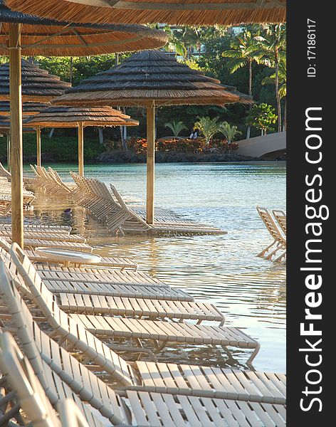 A row of beach chairs in line in the sand ready for relaxation. A row of beach chairs in line in the sand ready for relaxation