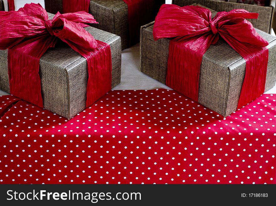 Hand made gift wrapped boxes with red crinkle paper bow tie. Hand made gift wrapped boxes with red crinkle paper bow tie