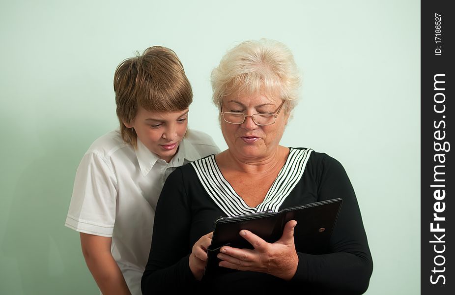 Grandmother and her grandson, read e-books. Grandmother and her grandson, read e-books.