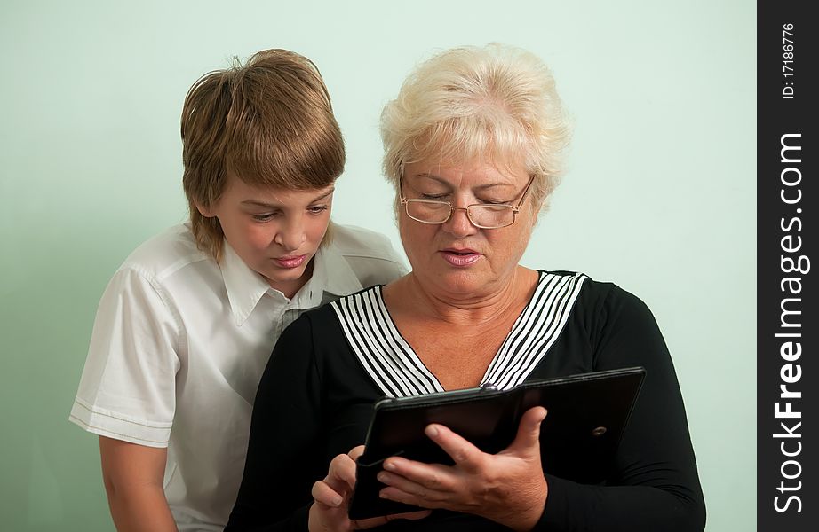 Grandmother and her grandson, read e-books. Grandmother and her grandson, read e-books.