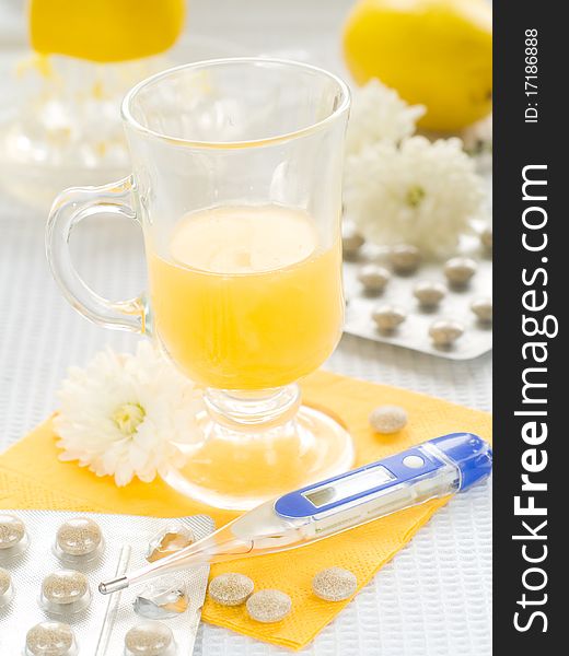 Hot drink with thermometer and pills