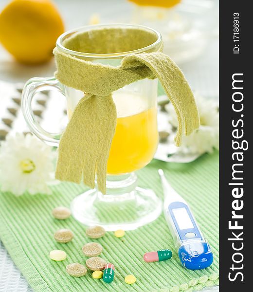 Hot drink with thermometer and pills