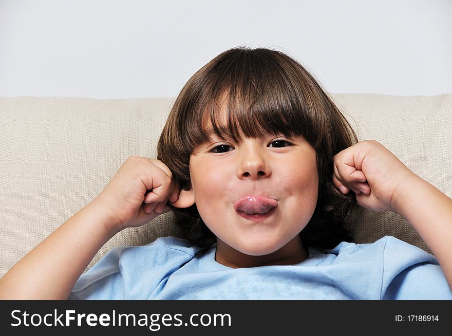 Little male portrait sitting on sofa