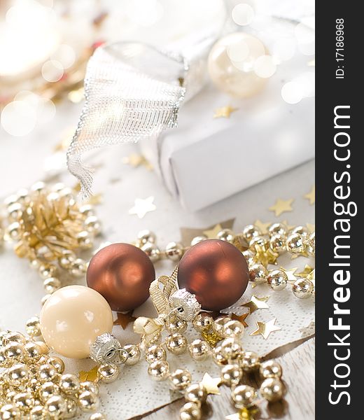 Christmas gift and baubles on defocused lights background. Christmas gift and baubles on defocused lights background