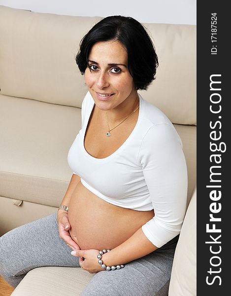 Pregnant woman sitting on sofa