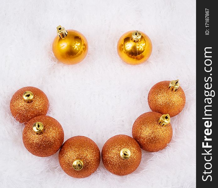 Christmas golden brightly spheres on the white fur