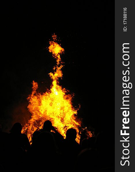 People in front of a fire during a festival