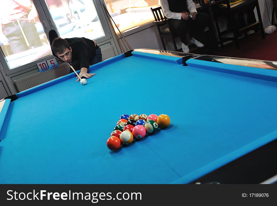 Young pro billiard player finding best solution and right angle at billard or snooker pool sport game. Young pro billiard player finding best solution and right angle at billard or snooker pool sport game