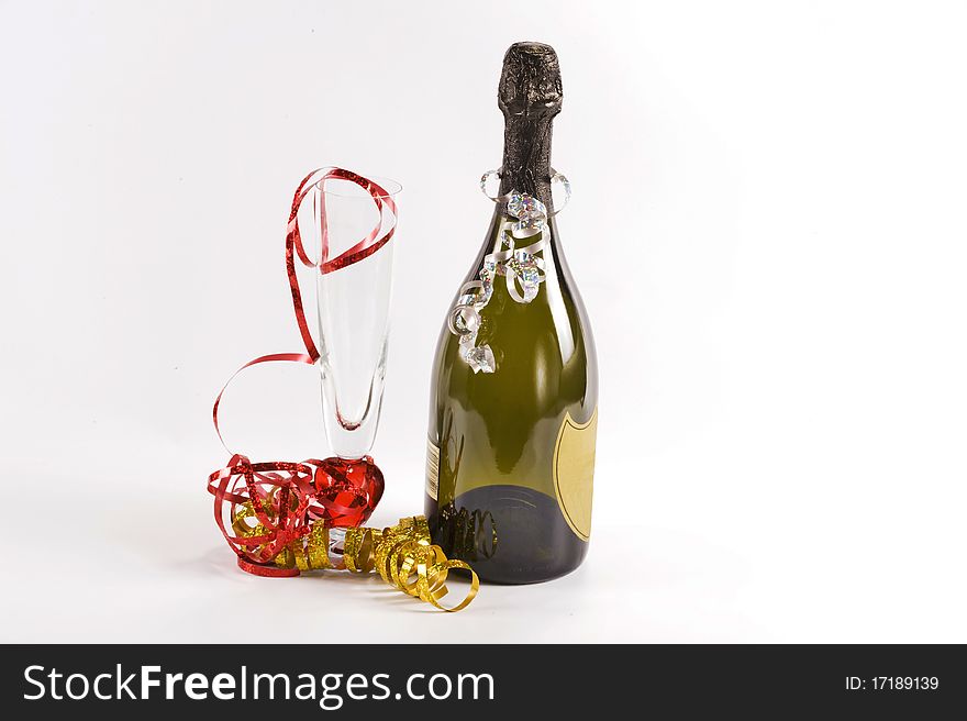 Bottle of champagne and flute  glass decorated with ribbons for christmas celebration. Bottle of champagne and flute  glass decorated with ribbons for christmas celebration